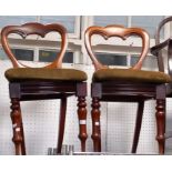 A pair of mahogany scroll back drop seat dining chairs