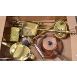 A box containing a selection of brass and copper fireside items