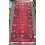 A woven wool red runner of geometric pattern