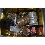 A tin box containing a quantity of costume jewellery mainly bangles