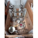 A box to include a pair of silver plate candle sticks, toast rack etc