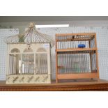 Two bird cages, one metal, the other wood