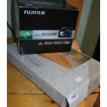A boxed Fuji S6500 digital camera with a boxed wooden basketball game