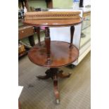 A Regency mahogany circular two tier dumb waiter, with reeded baluster columns on tripod base, 102cm