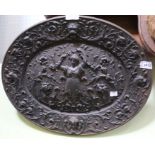 A cast iron plaque depicting maiden in flora & fauna