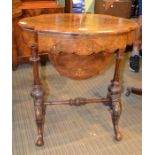 A walnut sewing table with pierced interior