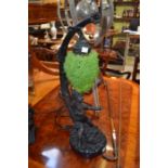 A reproduction cast resin figural table lamp with hanging grape decoration