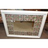 A large tile surround hanging wall mirror
