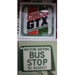 An enamel Western National bus stop sign with a framed Castrol sign