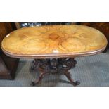 A mid-Victorian walnut topped fold over centre table on ornately carved folding four legged base, 74