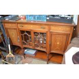 An Edwardian inlaid mahogany side unit having central drawer, over two fancy bevelled glazed doors,
