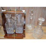 Two glass decanters and stoppers and a twin bottle tantalus with key