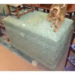 A large upholstered box ottoman
