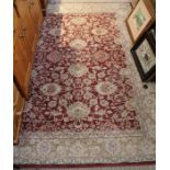 A modern machine woven floral carpet red and beige ground 238 x 170 cm