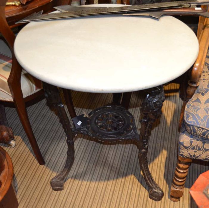 A wooden circular topped metal based Pub table