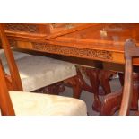 A reproduction dining table together with six chairs, chairs are in need of re-upholstery
