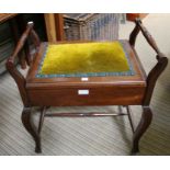 A pad topped piano stool with lift up lid