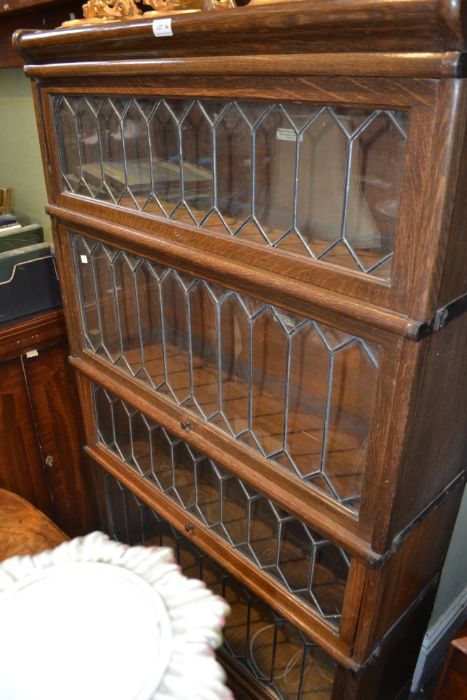 A Globe Wernicke oak four section bookcase, with typical leaded glass lift up front,
