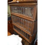 A Globe Wernicke oak four section bookcase, with typical leaded glass lift up front,