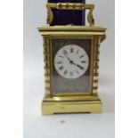 A late 19th century repeating carriage clock, brass case, the circular white enamel dial, with Roman