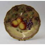 A Royal Worcester bone china plate, hand painted decoration, of fruit against a mossy bank, signed R