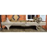 A pair of well weathered teak garden loungers by Westminster with pads