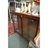 A mahogany finished glazed display cabinet on short cabriole legs