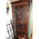A tall and narrow mahogany astragal fronted adjustable display case on carved cabriole legs