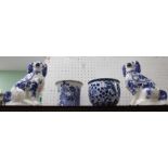 Four items of blue and white decorated pottery to include a pair of hearth spaniels
