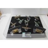 A display case of WWI & WWII aircraft and two tanks