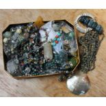 A tin of various costume jewellery, to include hardstone bead necklaces, amongst them malachite and