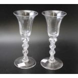 A pair of Georgian design ale glasses, with inverted bell bowls, opaque twist stems, on circular bas