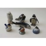 A collection of seven Royal Copenhagen ceramic figures, includes; frog, salmon, owl, penguin, etc.