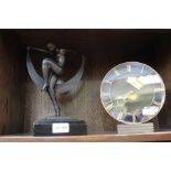 An art deco design mantle clock with an art deco design dancing naked female