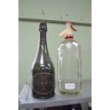 A bottle of 1997 vintage Cava, together with etched glass Soda Syphon