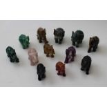 A collection of twelve carved stone elephants, various stones include malachite and Tigers eye, tall