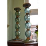 A pair of fancy glass and metal tall candle sticks