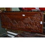 A gilt framed robing mirror together with a carved wooden panel depicting elephants
