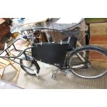 An old butchers delivery bike with traditional carry rack in need of restoration