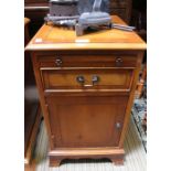 A yew wood bedside cupboard with brush slide and drawer