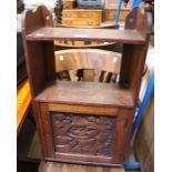 A small oak wall hanging cupboard with carved door