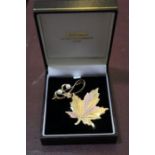 A 10k gold Maple leaf brooch, 8g, together with a 14k scroll brooch, set two cultured pearls, gross