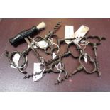A collection of Cellarman finger pull corkscrews and an ebonised handle corkscrew with brush
