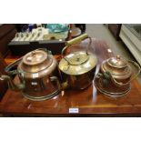 Two copper kettles plus a brass example