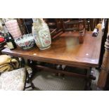 A dark wood draw leaf dining table