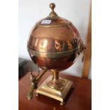 A copper metal urn with tap