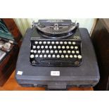 Cased Olympia typewriter and a vintage Remington Home Portable