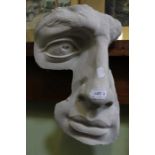 A modern half plaster sculpture of a human face