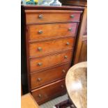 A tall modern chest of six drawers