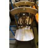 A set of four fiddle back wooden kitchen chairs